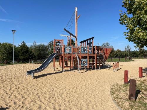 a playground with a slide in the sand at Gospodarstwo Agroturystyczne u Wojciecha in Pakosław