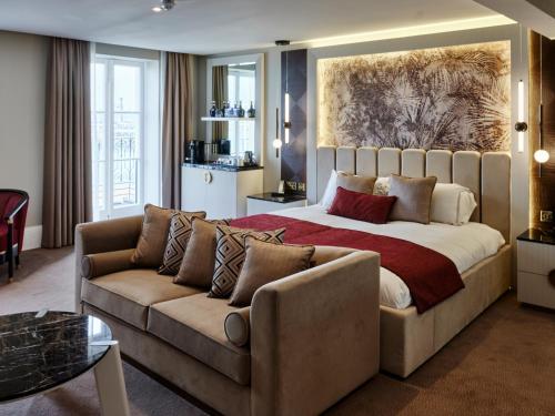 a bedroom with a large bed and a couch at Dover Marina Hotel & Spa, Tapestry Collection by Hilton in Dover