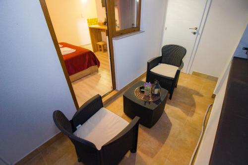 a room with a mirror and two chairs and a table at Villa Deny Mostar - with free parking in Mostar
