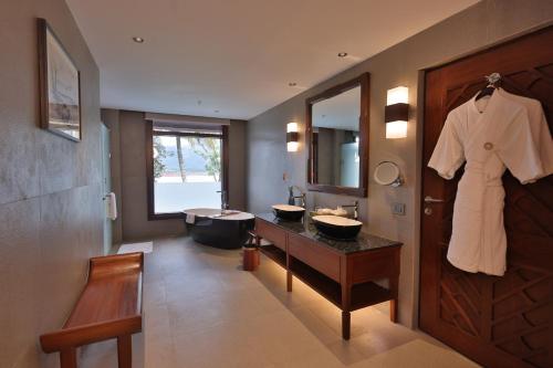 a bathroom with two sinks and a bath tub at Taj Wayanad Resort & Spa, Kerala in Wayanad