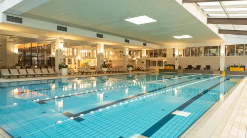 a large swimming pool in a large building at Hotel Terme Jezercica in Donja Stubica
