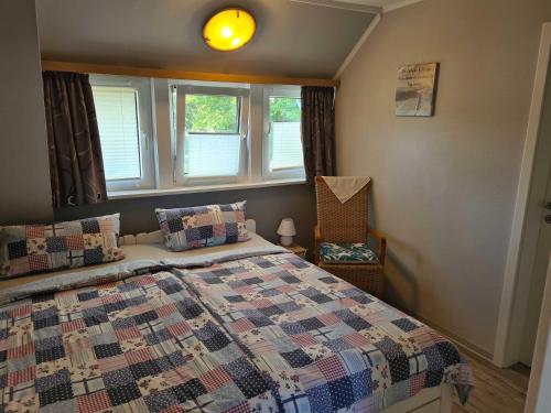 a bedroom with a bed with a quilt on it at Haus Katharina in Barßel