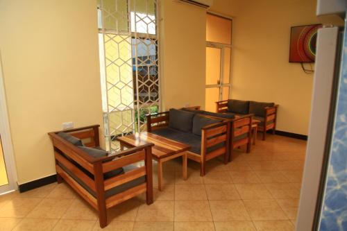 a waiting room with chairs and tables and a stained glass window at Johnsons Villas in Zame