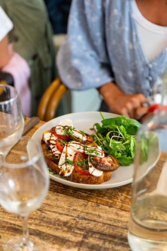 a plate of food with a salad on a table at The Georgian House in Alderney