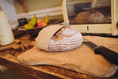 a loaf of bread sitting on top of a cutting board at The Georgian House in Alderney
