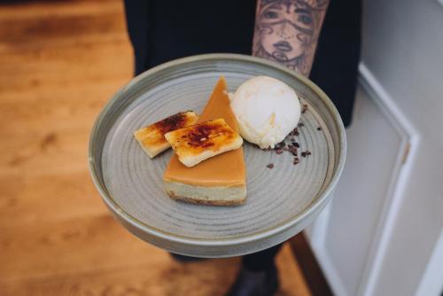 a plate of food on a table with a plate of desserts at The Georgian House in Alderney