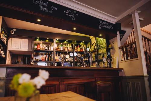 a bar with a lot of bottles of alcohol at The Georgian House in Alderney