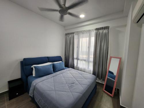 a bedroom with a blue bed and a mirror at One Bedroom Troika Kota Bharu by AGhome in Kota Bharu