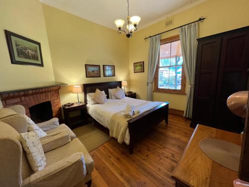 a bedroom with a bed and a couch at Tillietudlem Nature Reserve in Impendle