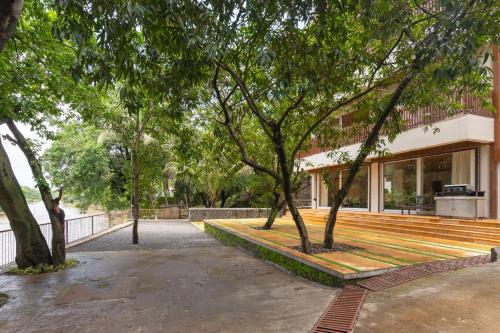 a building with trees in front of it at LohonoStays Villa Athini in Chinchavli