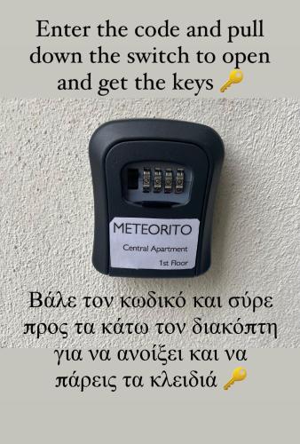 a scale on a wall with the words enter the code and pull down the switch at METEORITO central apartment in Kalabaka