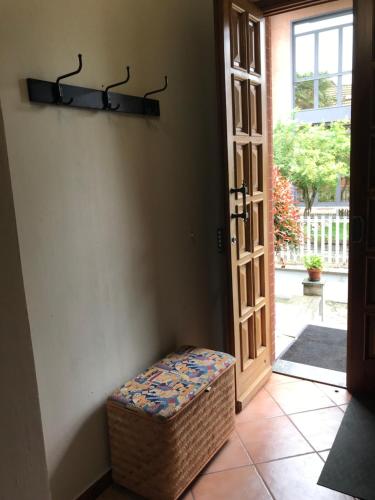 a door to a room with a wicker ottoman in front of it at L’ulivo in Ciriè