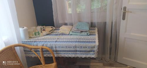 a table with towels and a table with a window at logement indépendant attenant à une maison dans grand jardin in Retournac