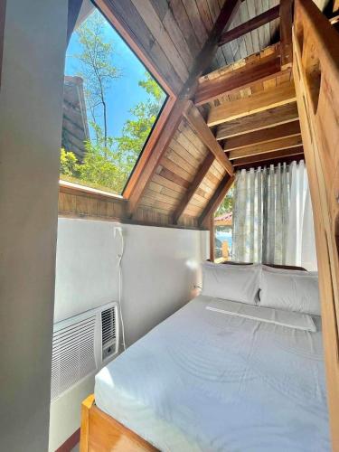a bed in a room with a large window at A-House Beachfront in Bootin