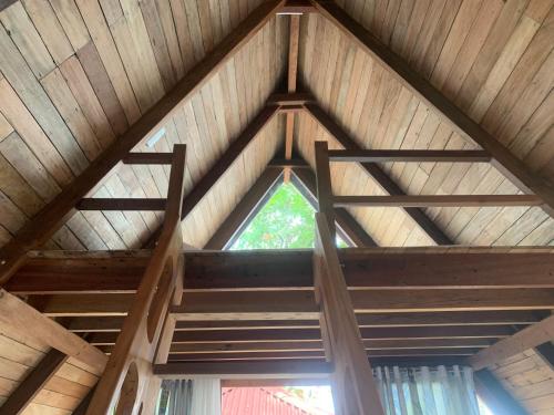 a wooden ceiling with a window in a cabin at A-House Beachfront in Bootin