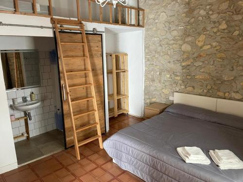 a bedroom with a bunk bed and a ladder at Cal Tomaset in Las Cabanyas