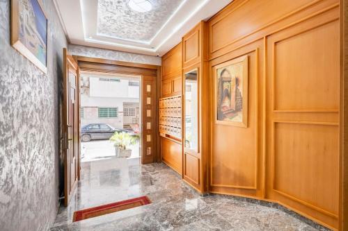 a hallway with wood paneled walls and a door at TT Holidays Cosy apartment Rabat City Center in Rabat