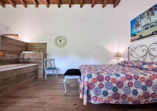 a bedroom with a bed and a bathroom with a sink at Apartamentos Rurales Sobremazas in Sobremazas