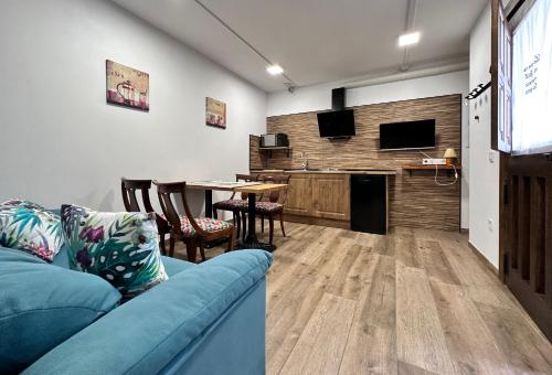 a living room with a blue couch and a table at Apartamentos Rurales Sobremazas in Sobremazas