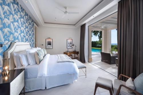 a bedroom with a bed and a living room at Villa Tamarindo Luxury Beachfront Villa in Saint James