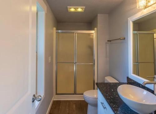 a bathroom with a shower and a sink and a toilet at PA Sea View Deck House in Port Angeles