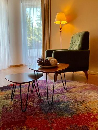 a living room with a couch and a coffee table at Vila Diana - Poiana Brasov with breakfast optional at hotel Simona Halep in Poiana Brasov