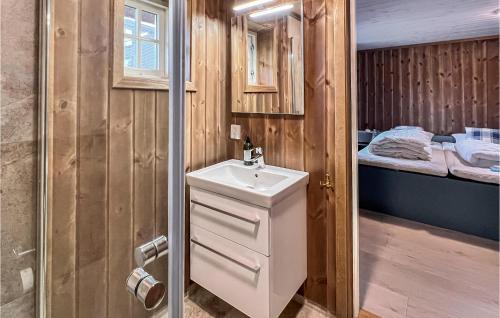 a bathroom with a sink and a bed at Lovely Home In Svingvoll With Sauna in Svingvoll