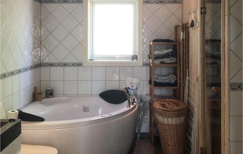 a bath tub in a bathroom with a window at Stunning Home In lvdalen With Sauna in Älvdalen