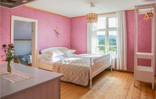 1 dormitorio con cama y pared de color rosa en Lovely Home In Ramvik With Kitchen, en Ramvik