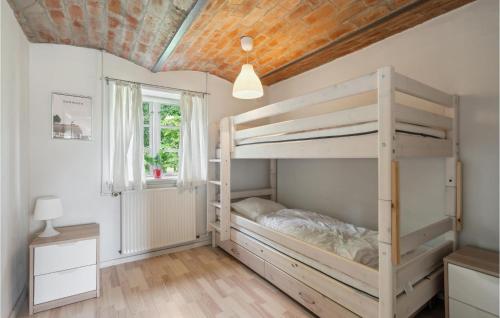 a bedroom with a bunk bed and a wooden ceiling at 2 Bedroom Pet Friendly Apartment In Ringkbing in Ringkøbing