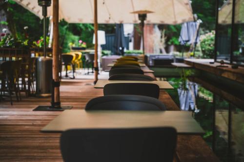 a row of tables and chairs at a restaurant at Utopia Hotel - Art & Nature Hotel in Mons