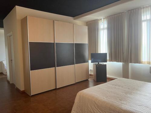 a bedroom with a large wardrobe and a bed at Winter Home G&D in Milano Marittima