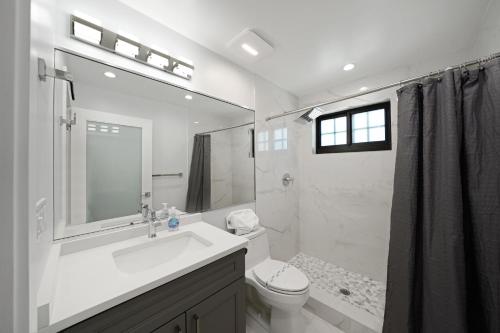 a white bathroom with a sink and a toilet at Dania Beach Unit 1 By Pmi in Dania Beach