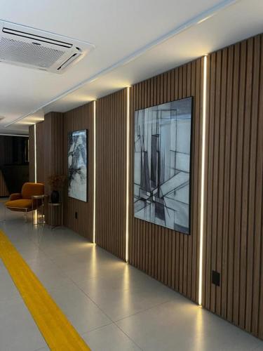a hallway with a large painting on the wall at Studio no West Fit Mossoró Nova Betania in Mossoró