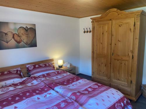 a bedroom with a bed and a wooden cabinet at Apartment Margherita in Sedrun