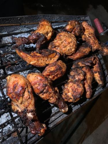 a bunch of chicken cooking on a grill at Superview Lodge Sarangkot in Pokhara