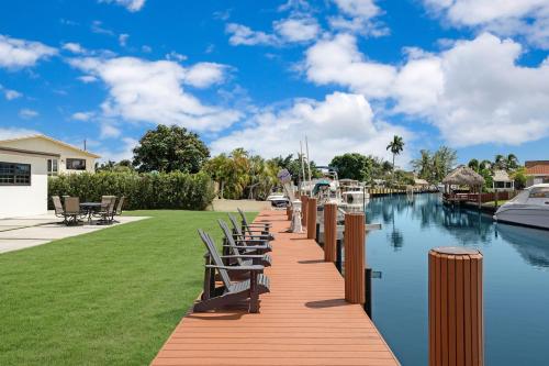 a wooden dock with chairs and a marina at Dania Beach Unit 1 By Pmi in Dania Beach