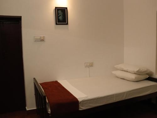A bed or beds in a room at Remasailam Homestay - Thiruvananthapuram , Calm & Blend with Nature