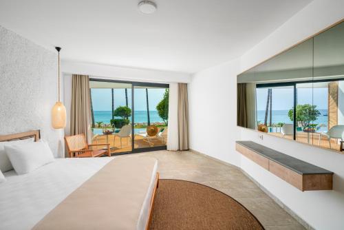 a hotel room with a bed and a view of the ocean at Yalihan Aspendos in Alanya