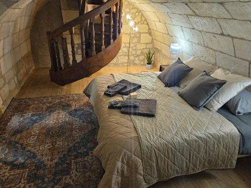 a bedroom with a bed in a brick wall at Hotel Robin Quantin in the heart of Old Tours in Tours