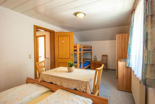 a dining room with a table and chairs in a room at Ferienhaus Englacher in Ebensee