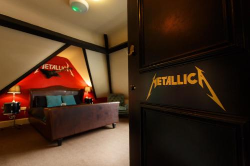 a bedroom with a bed with a red tent at The Saddle Inn in Chester