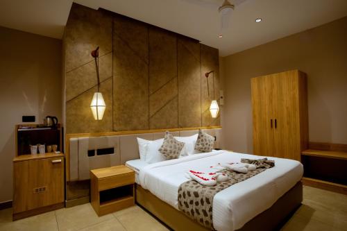 a bedroom with a large bed with shoes on it at Beeza Clubhouse in Kottayam