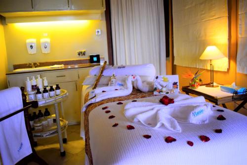 a bedroom with a bed with roses on it at Lake Elmenteita Serena Camp in Elmenteita