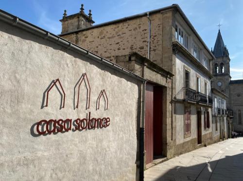 an old building with a sign on the side of it at CASA SOLANCE in Sarria