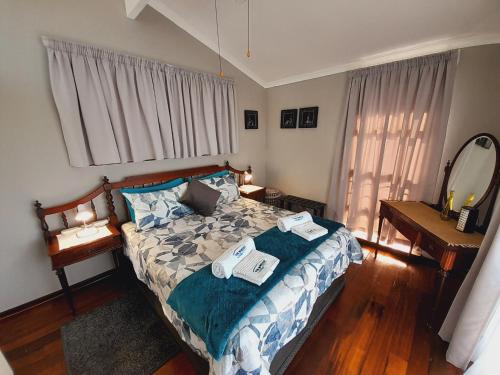 a bedroom with a bed with two towels on it at Sea Breeze Shelly Beach in Shelly Beach