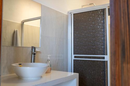 a bathroom with a sink and a shower at FINCA EL PORVENIR in Acacías
