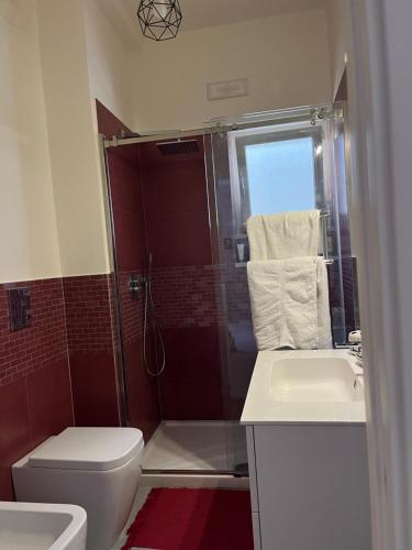 a bathroom with a shower and a toilet and a sink at Wave House in Palermo