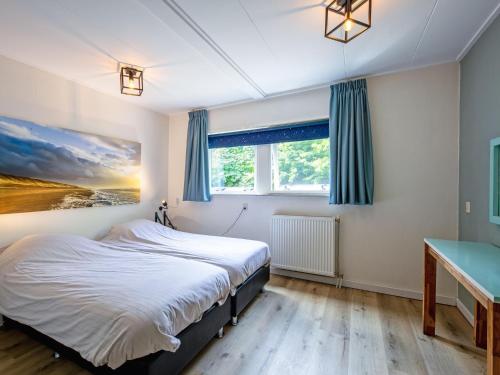 a bedroom with a bed and a desk at Cozy holiday home in Den Burg with hot tub in Den Burg