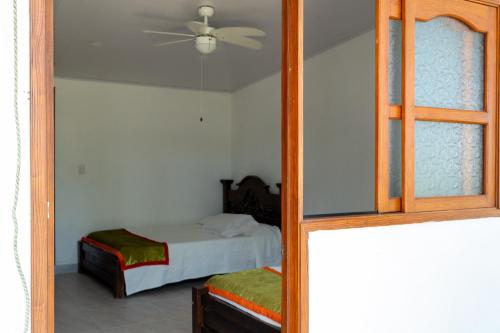 a bedroom with a bed and a mirror at FINCA EL PORVENIR in Acacías